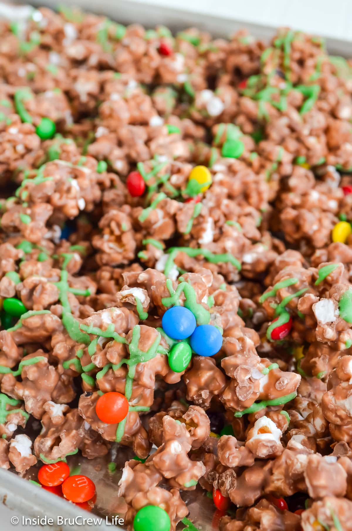 A tray filled with chocolate hazelnut popcorn and candy.