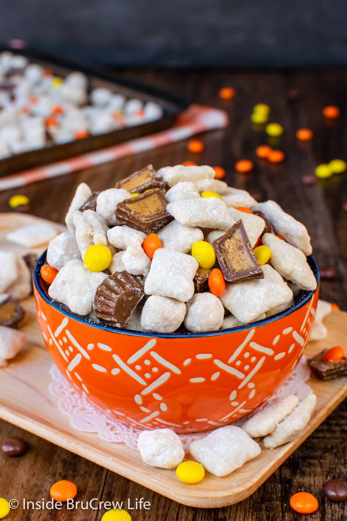An orange bowl full of Reese's puppy chow.