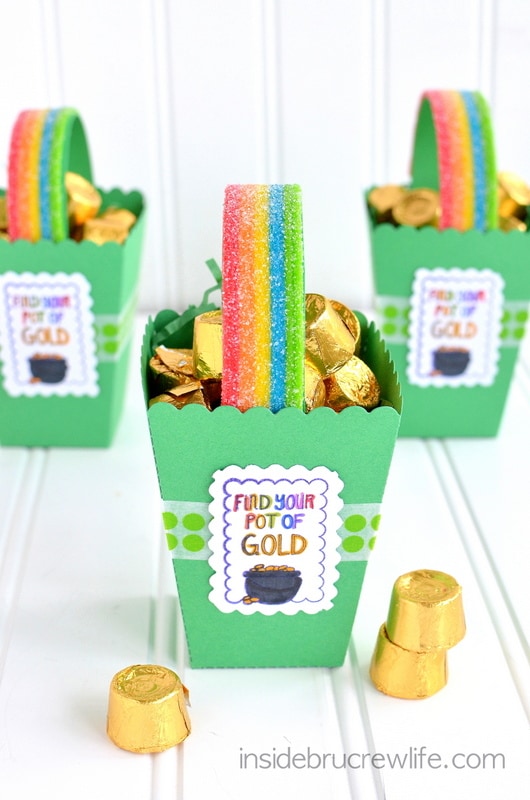 Rainbow candy stips and gold Rolos inside three popcorn boxes.