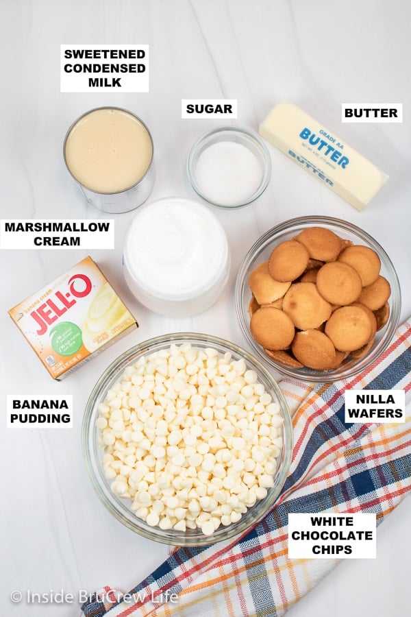 A white board with bowls of ingredients for banana fudge.