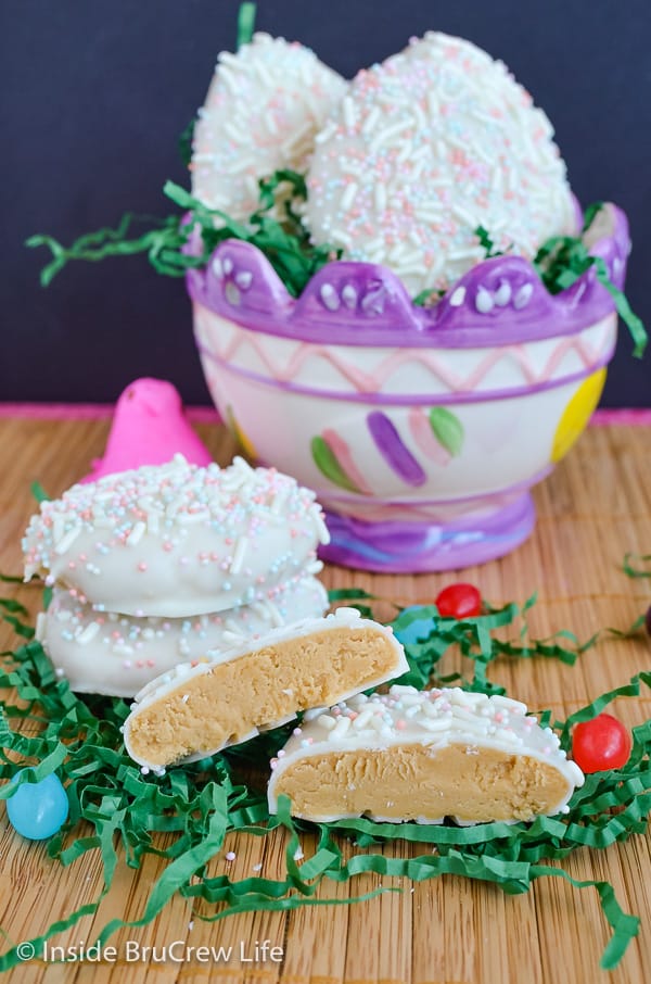 A glass Easter basket with cookie butter eggs in it and a few eggs cut in half out in front