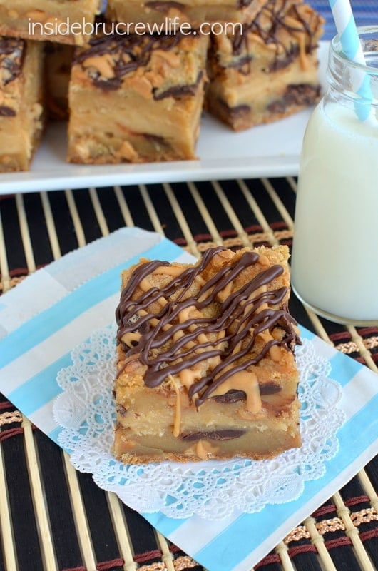 Peanut Butter Cheesecake Cookie Bars - peanut butter cheesecake in the middle of peanut butter and chocolate chunk cookie bars