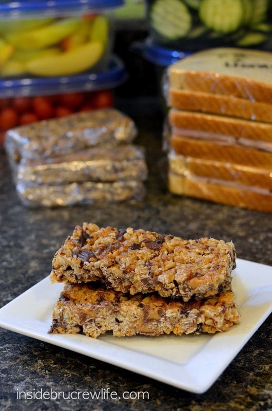 A white plate with two homemade granola bars stacked on it