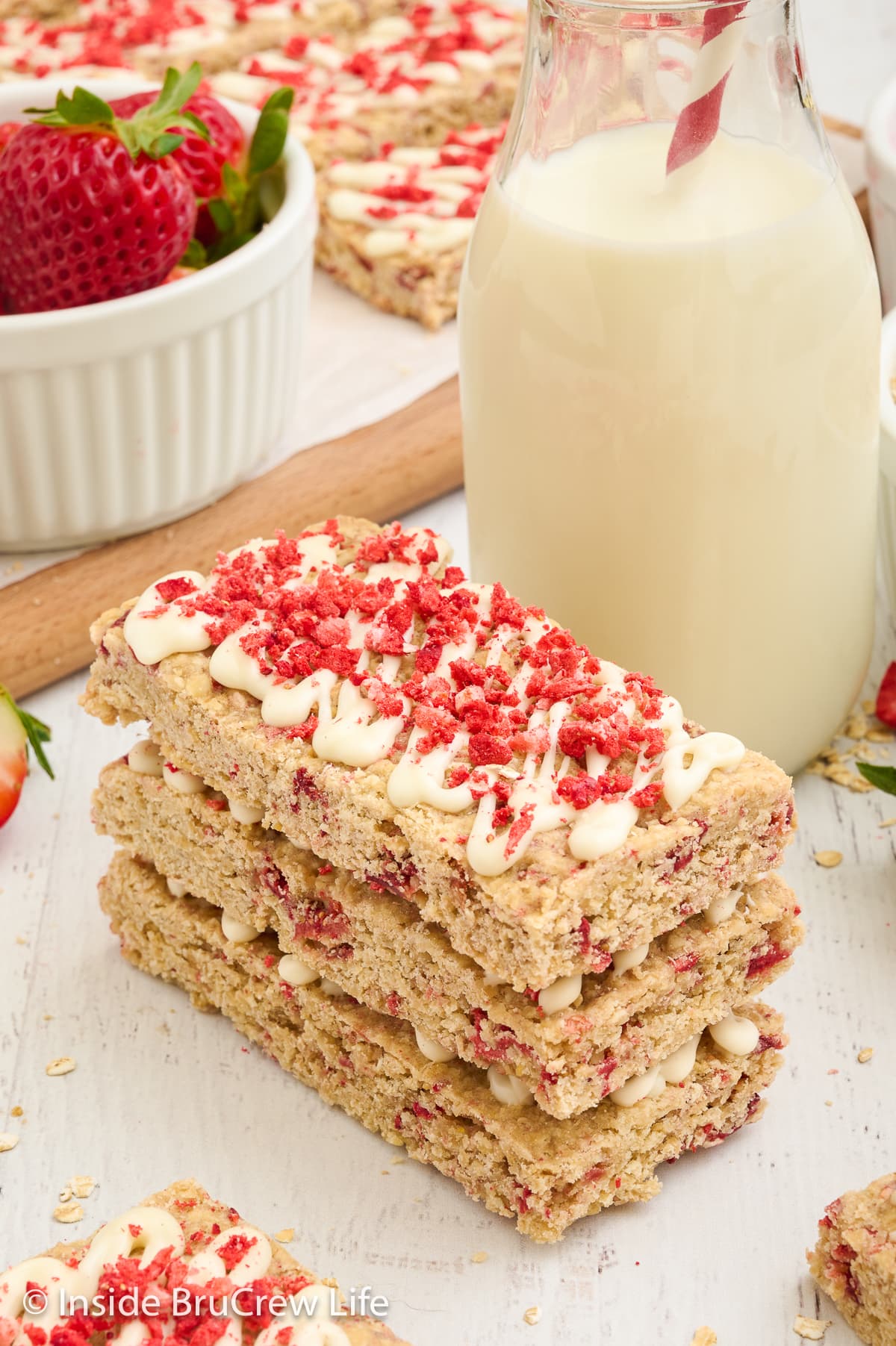 A stack of granola bars on a white board.