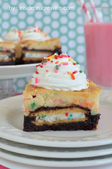 Brownies with Oreo cookies inside and cake batter cheesecake on top is the perfect dessert for celebrating anything!