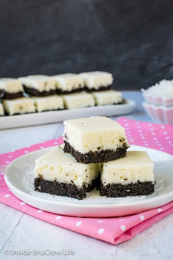 3 pieces of white coconut fudge with an oreo cookie base on a white plate.