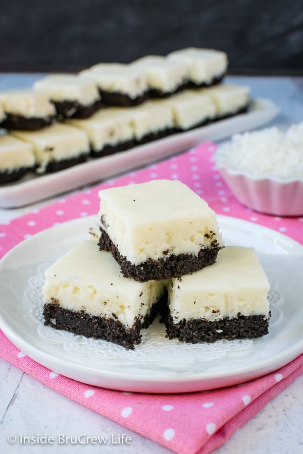 3 pieces of white coconut fudge with an oreo cookie base on a white plate.