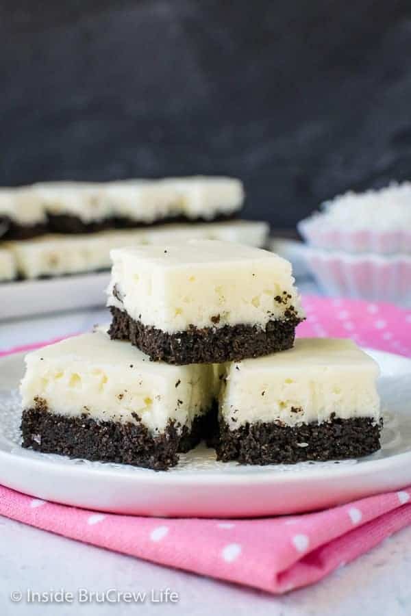 3 pieces of white coconut fudge with an oreo cookie base on a white plate.
