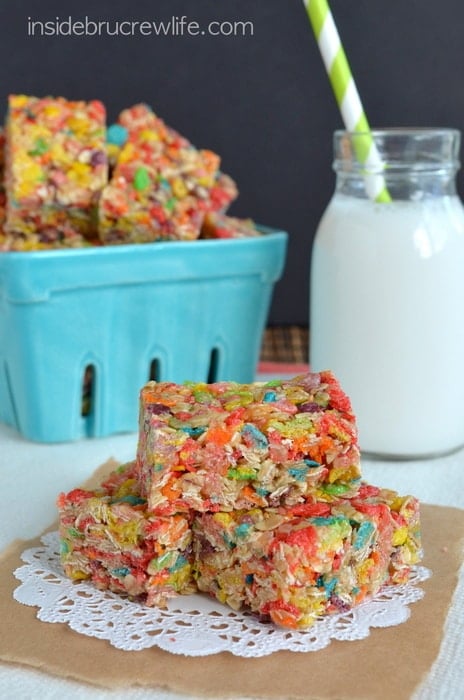 A white doily with three fruity pebbles granola bars stacked on it