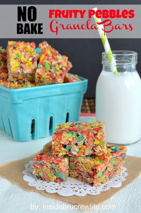 Three fruity pebbles granola bars stacked on each other on a white doily
