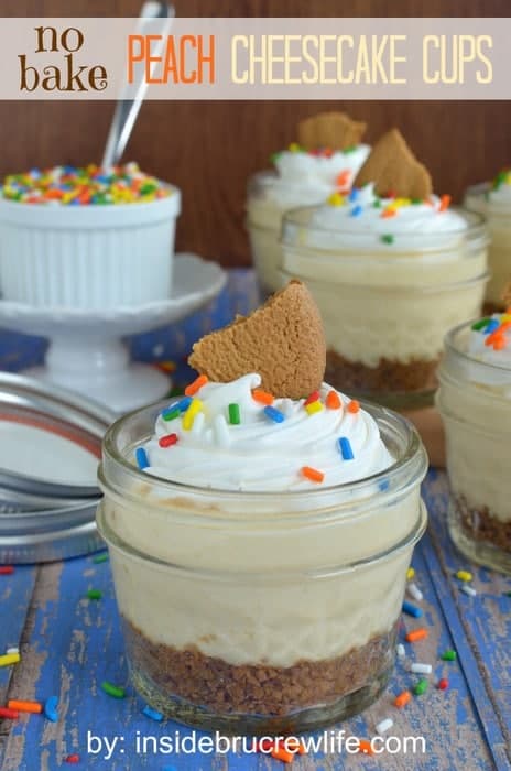 Glass jars filled with a cookie crust and a creamy peach filling.