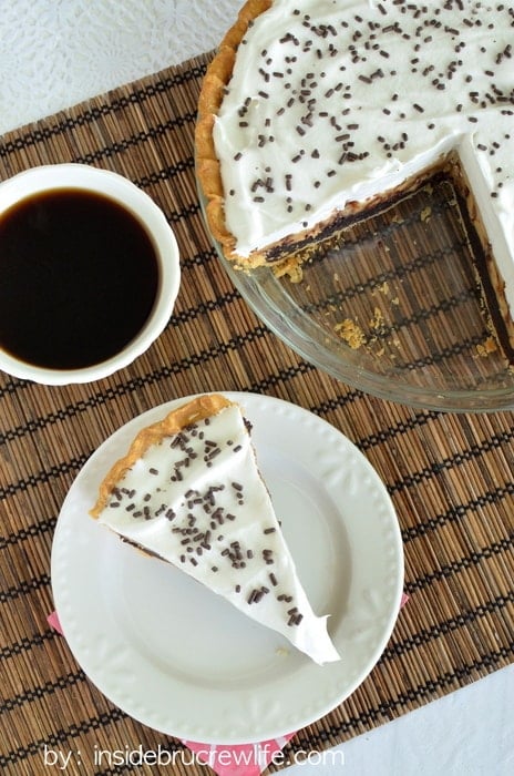 Peanut Butter Snickers Cheesecake Brownie Pie - peanut butter cheesecake on a brownie crust is a great way to do pie! Easy recipe to make for parties! #pie #brownie #cheesecake #peanutbutter #snickers