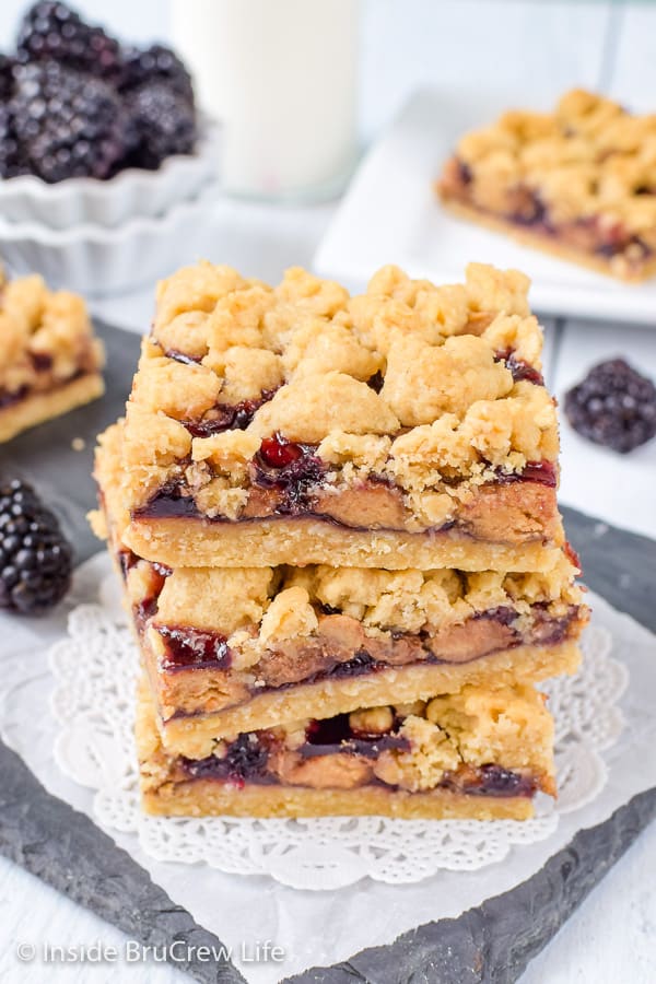 Peanut Butter and Jelly Crumb Bars - peanut butter cups and blackberry preserves add a fun peanut butter and jelly twist to these crumble bars. Try this easy recipe for a fun dessert or after school snack! #peanutbutterandjelly #cookiebars #peanutbuttercups #blackberry #backtoschool