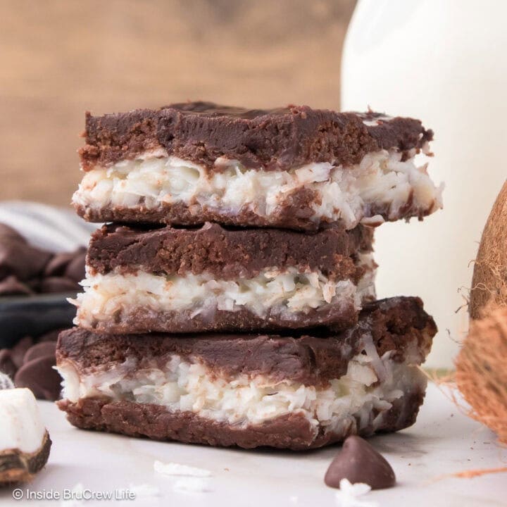 Three chocolate coconut bars stacked on top of each other.