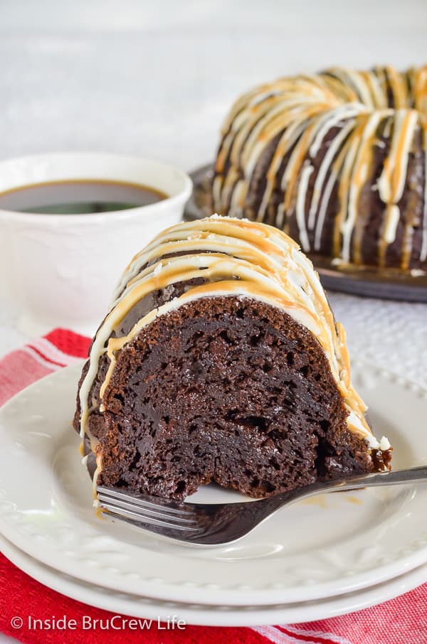 A white plate with a slice of salted caramel bundt cake on it.