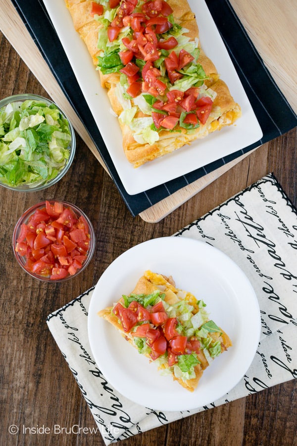 A full BLT chicken braid on a long white plate with a slice on a round white plate beside it