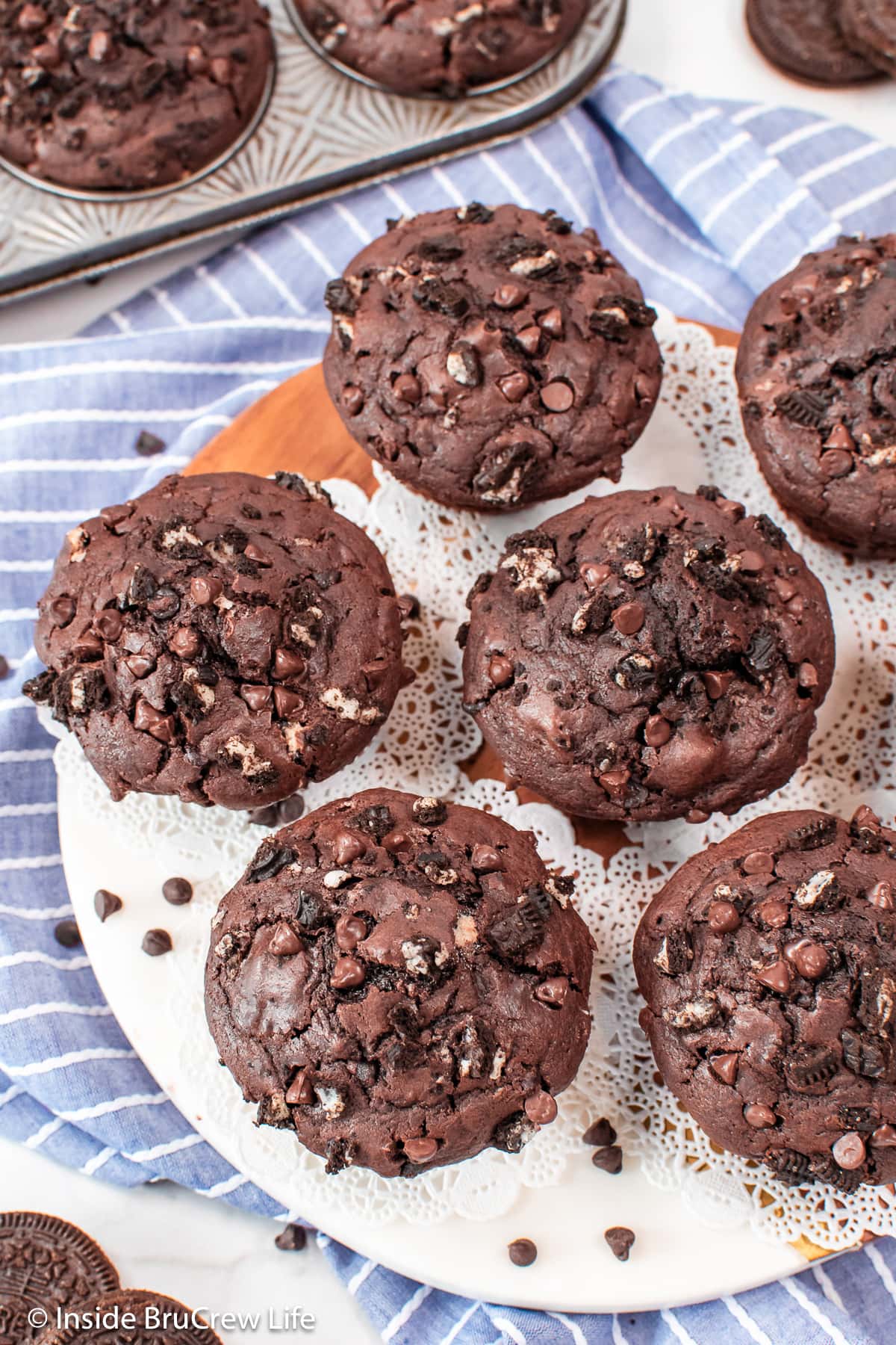A batch of chocolate cookie muffins on a white tray.
