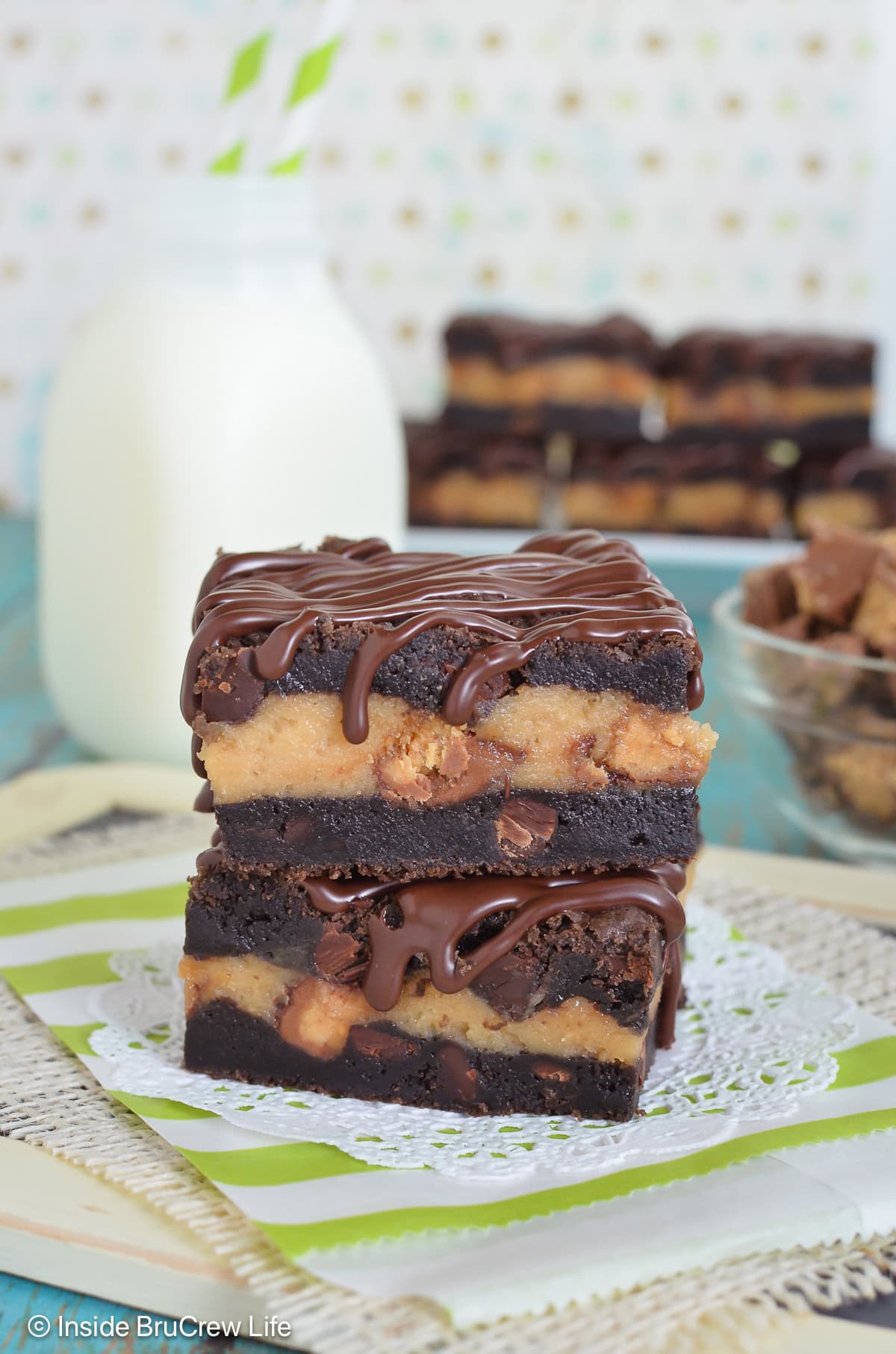 Two chocolate cheesecake cookie bars stacked together.