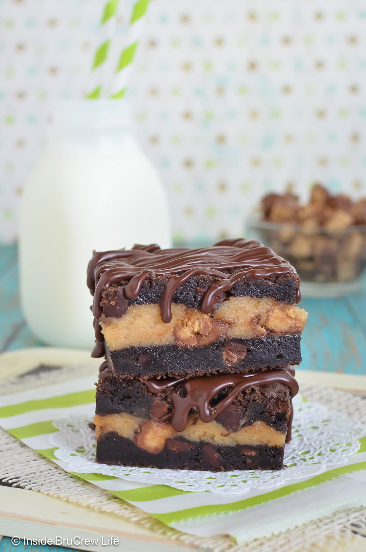 Two cookie cheesecake bars stacked together.