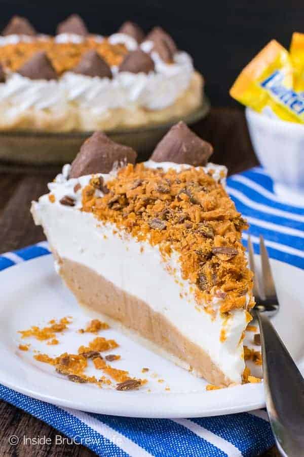 Peanut Butter Butterfinger Pie - the creamy cheesecake layers and crunchy candy bar creates a delicious pie. Perfect recipe for the holidays! #pie #butterfinger #holiday #peanutbutter