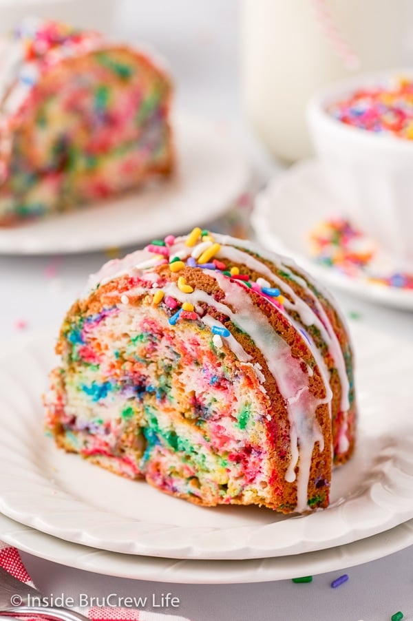 A slice of vanilla bundt cake with sprinkles baked into it.