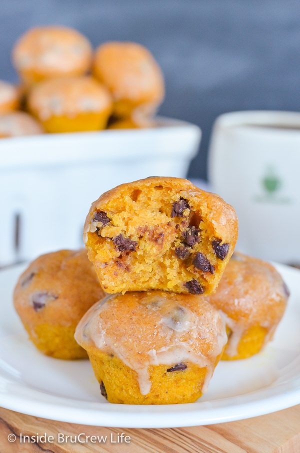 A white plate with a stack of pumpkin mini muffins on it.