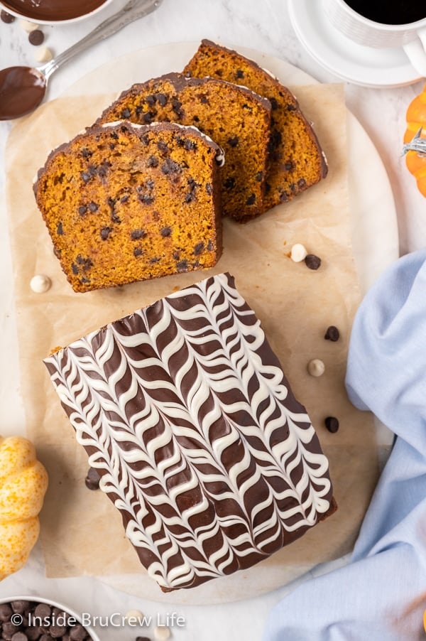 Overhead picture of a loaf of pumpkin bread topped with pretty chocolate drizzles.