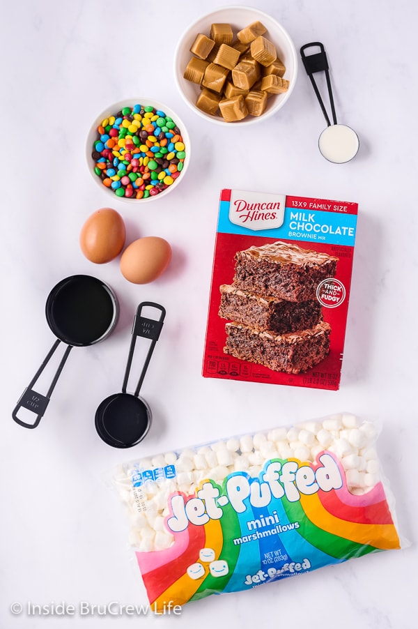 A white board with ingredients needed for brownies with marshmallows.