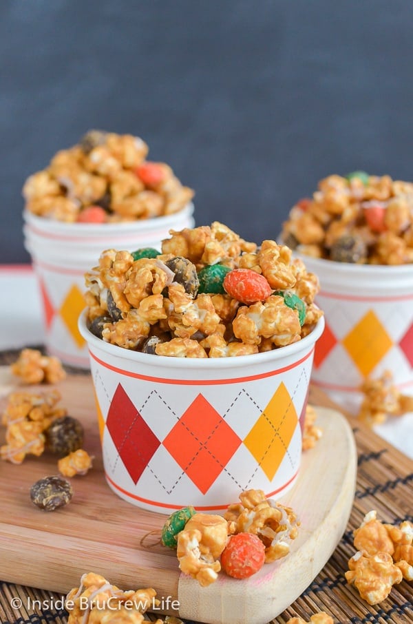 Caramel Pumpkin Spice Popcorn - pumpkin spice candies and marshmallows add a fun flair to this caramel covered popcorn mix. Make this easy recipe for fall parties!