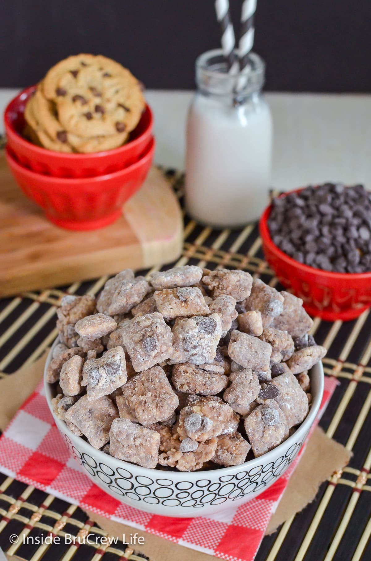 A bowl filled with muddy buddies and chocolate chips.