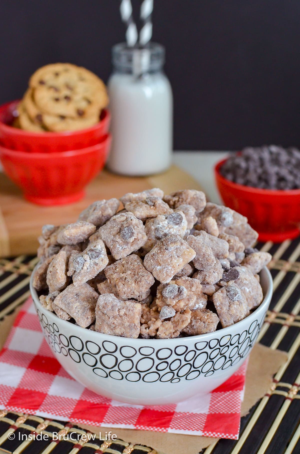 A white bowl filled with chocolate chex muddy buddies.