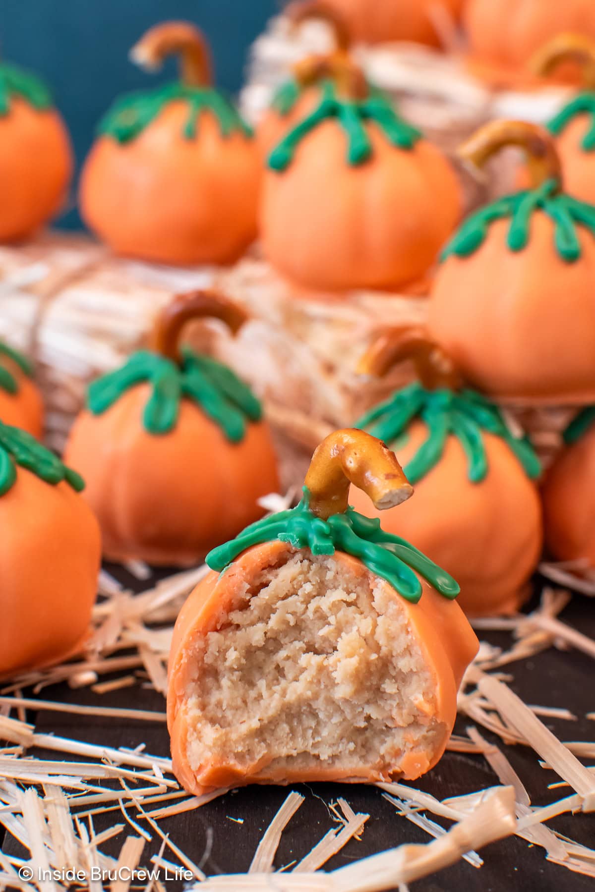 Orange pumpkins with a bite of one showing the fluffy peanut butter inside.