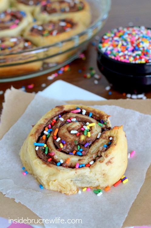 A sweet crescent roll filled with chocolate and topped with sprinkles.