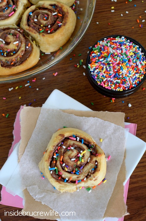 Crescent rolls filled with chocolate and sprinkles in a pie plate.