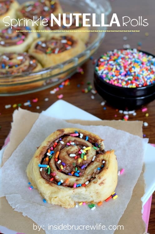   Crescent rolls filled with chocolate and topped with sprinkles.