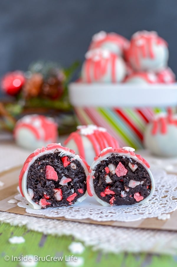 A white doily with two Peppermint Crunch Oreo Truffles on it cut in half