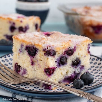 A close up of a piece of blueberry snack cake on a blue plate.