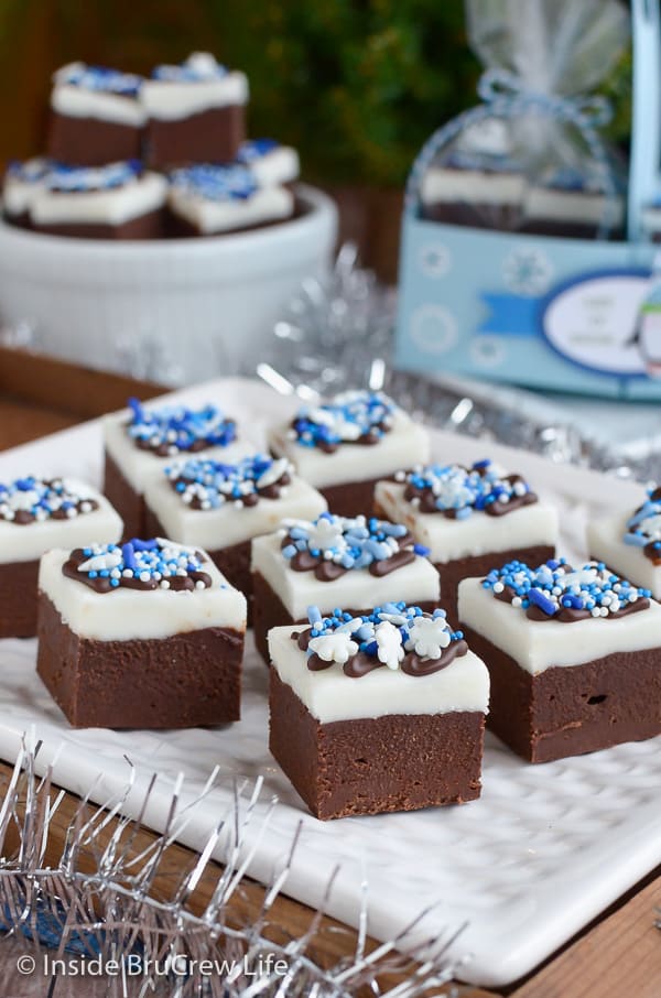 Chocolate Peppermint Fudge topped with blue and white sprinkles on a white plate.