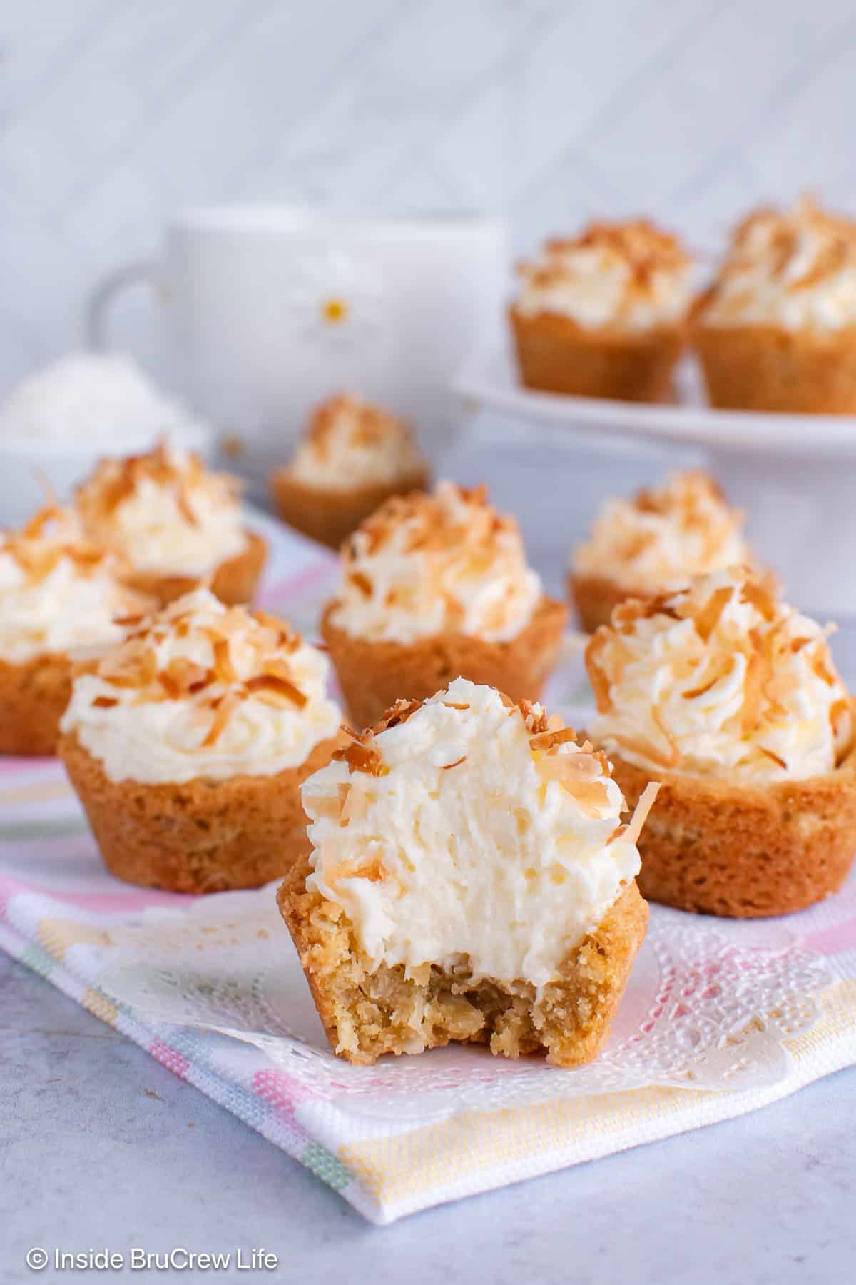 Filled coconut cream cookie cups on a gray board.