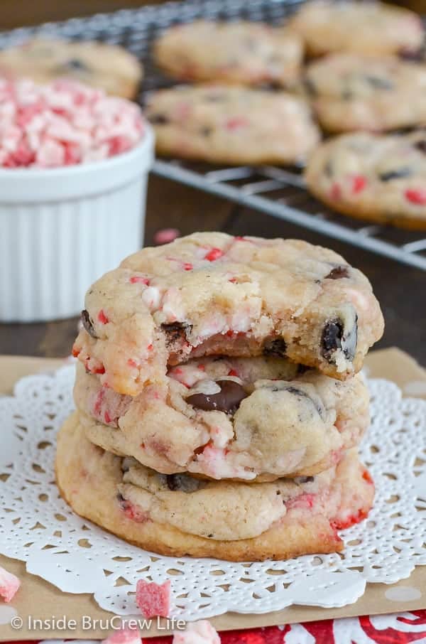 A white doily with three oreo peppermint crunch cookies stacked on it with a bite out of the top cookie