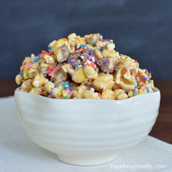 Peanut Butter Candy Bar Popcorn from www.insidebrucrewlife.com - white chocolate, peanut butter, and candy bars make this a snack you can't stop munching on