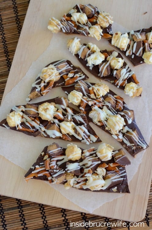 Pieces of chocolate candies cut up on a board.