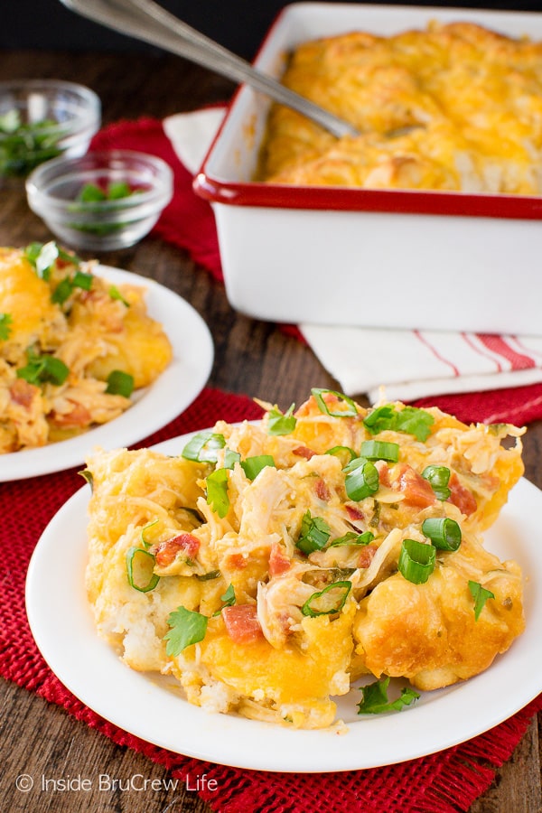 Fiesta Chicken Nacho Bake - adding tomatoes, biscuit, and cheese makes this chicken casserole so easy and delicious. Great dinner recipe for cold nights!