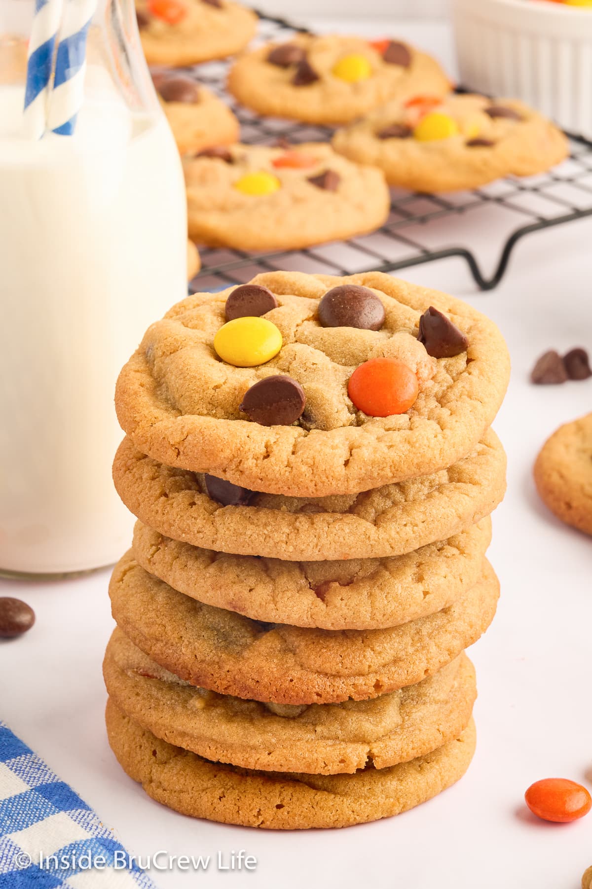 A stack of peanut butter cookies on a white board.