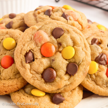 A very close up of a peanut butter cookie with Reese's Pieces.