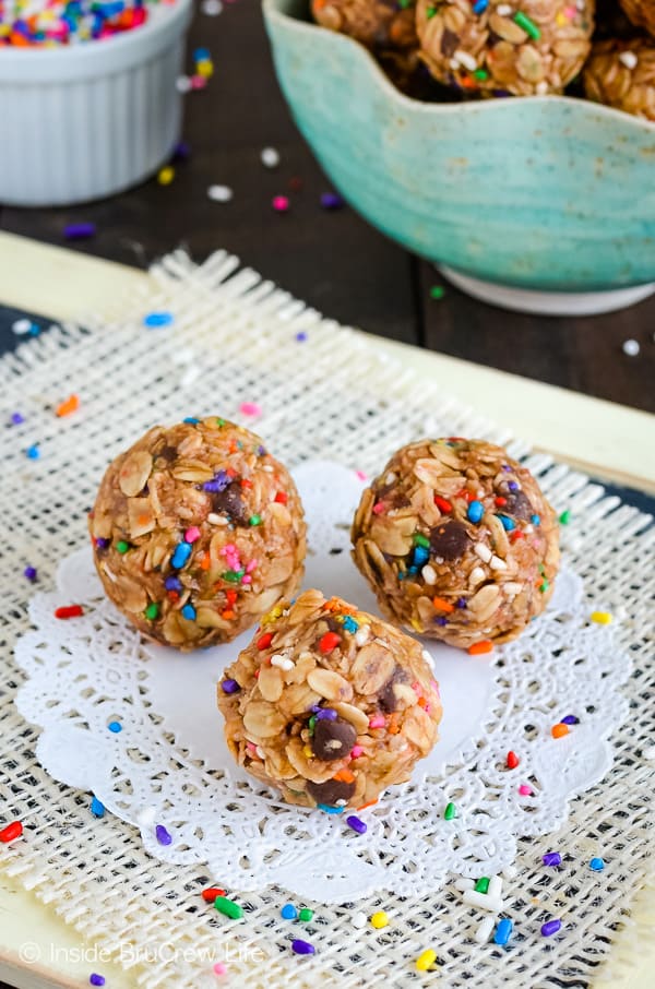 Three peanut butter granola bites on a white doily