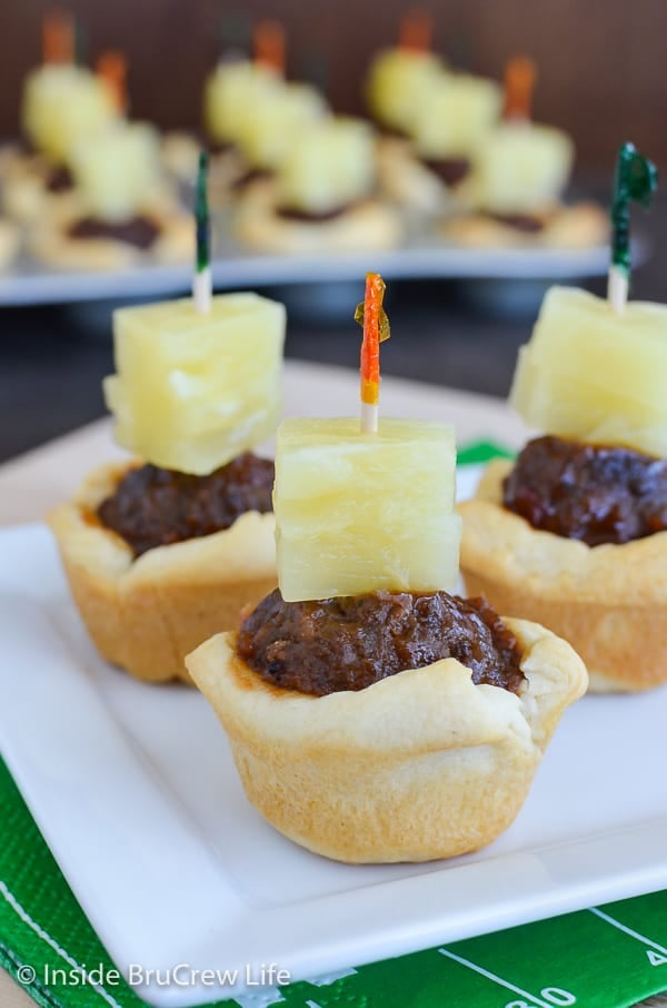 Tropical Meatball Crescent Cups - add barbecue meatballs and pineapple to a little crescent roll cup for a quick and easy appetizer. Make this recipe for game day parties this fall! 