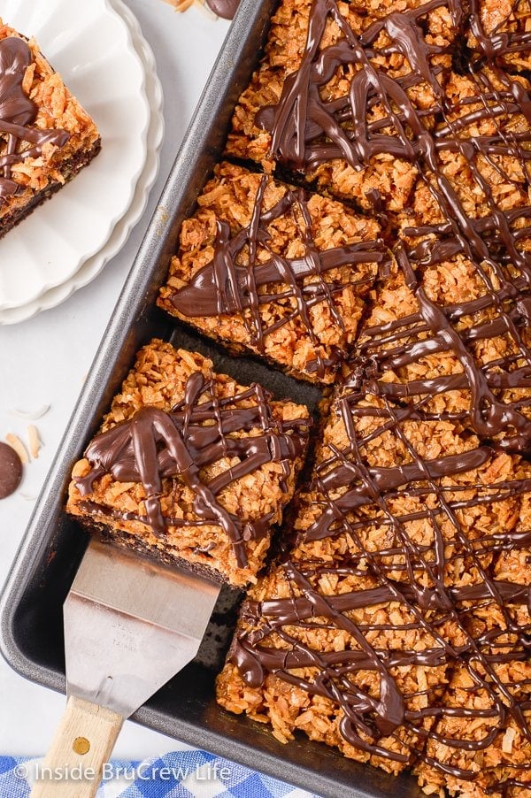Overhead picture of a pan with caramel coconut topped brownies in it.