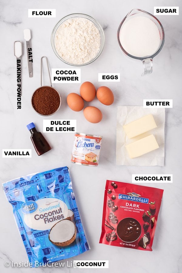 A white board with ingredients to make brownies with caramel and coconut.