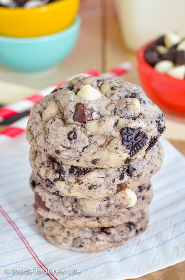 A stack of cookies n cream cookies on a white napkin.